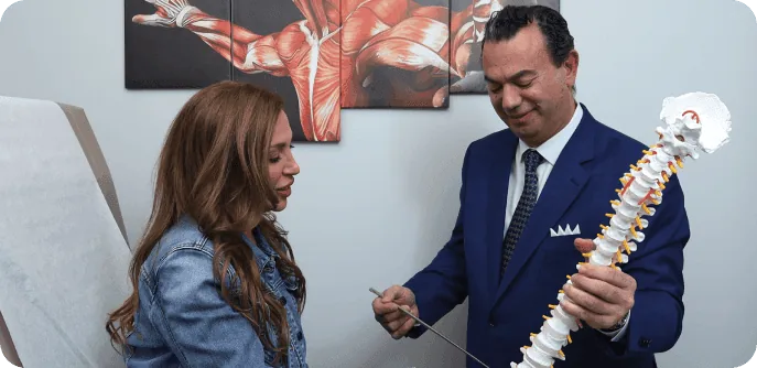 Dr. Sakr discussing spine anatomy with a patient